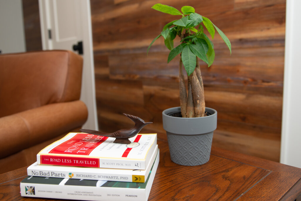 Books next to a plant